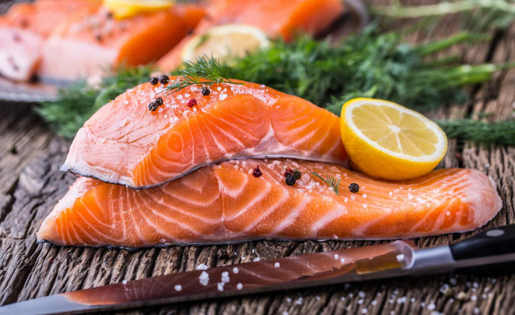 salmon fish garnished with lemon and veggies for brain health