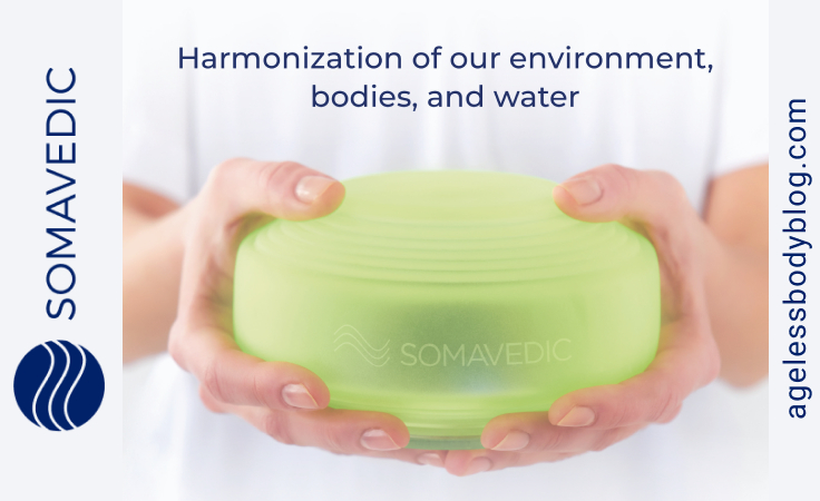 a biohacker holds somavedic medic green ultra to harmonize water