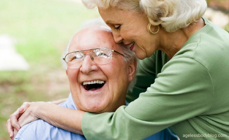 a senior couples hugs each other after balance exercise in the park