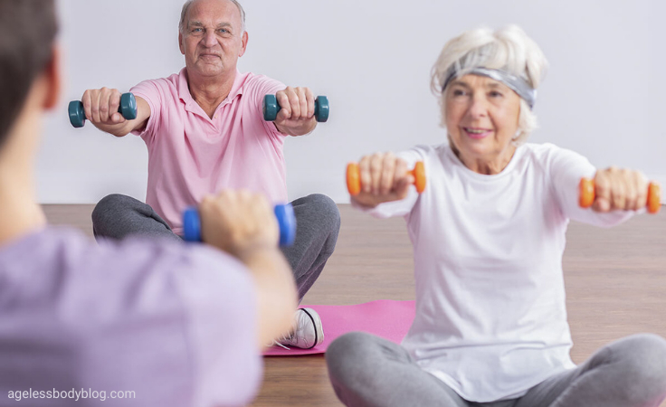 senior citizens lifts dumb bells in their balanced exercises therapy session