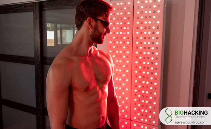 a biohacker stands against Joovv red light therapy stand